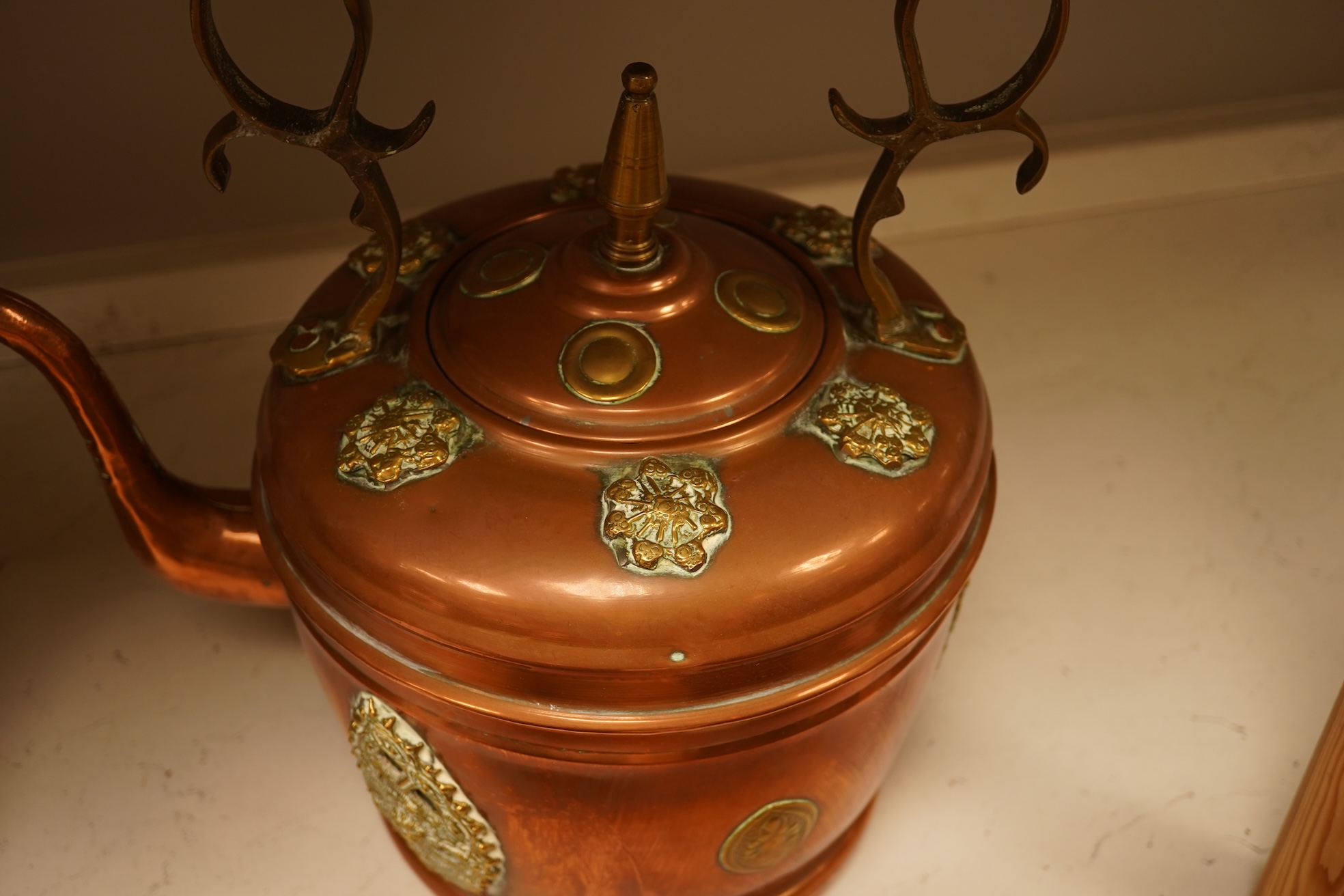 Four various copper vessels and a brass teapot, tallest 47cm